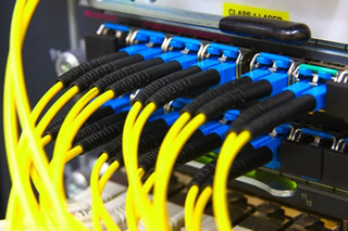 Technician terminating fiber optic cabling inside a Norfolk VA office